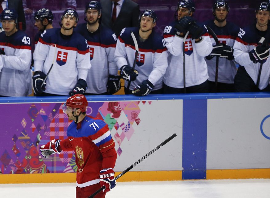 Russia forward Ilya Kovalchuk skates by the Slovakian bench after scoring the winning goal in a shootout of a men's ice hockey game at the 2014 Winter Olympics, Sunday, Feb. 16, 2014, in Sochi, Russia. Russia won 1-0. (AP Photo/Julio Cortez)