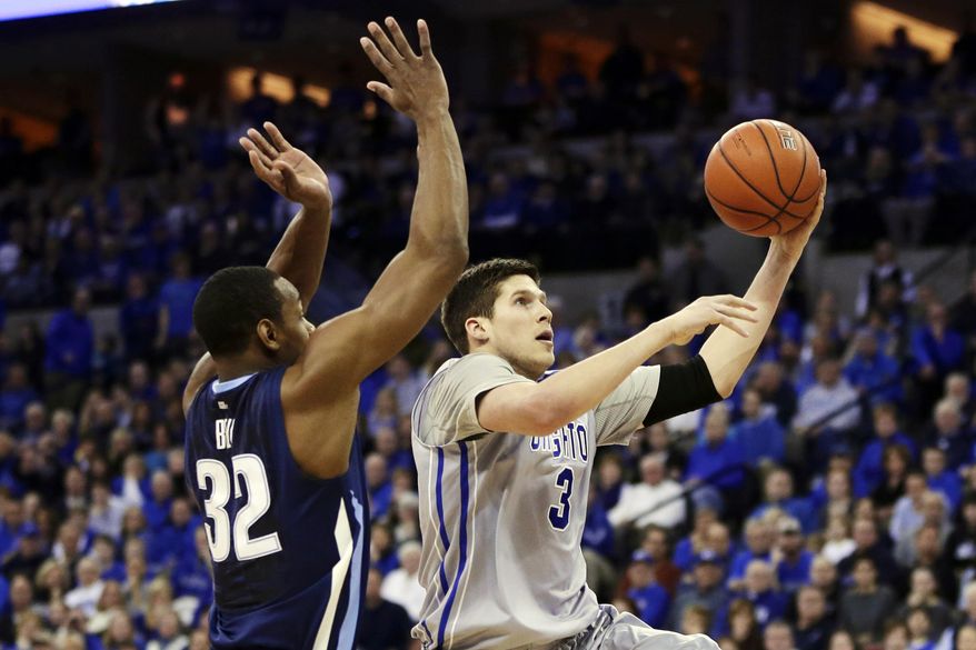 Creighton's Doug McDermott (3) goes for a layup against Villanova's James Bell (32) in the first half of an NCAA college basketball game in Omaha, Neb., Sunday, Feb. 16, 2014. (AP Photo/Nati Harnik)