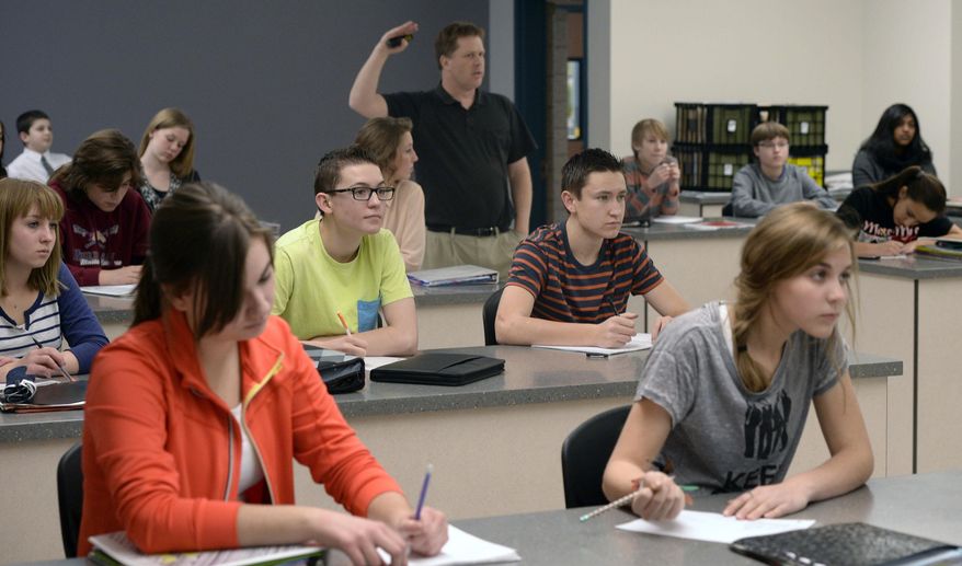 Ninth grade students in John Schneggenburger's biology class learn how to map pedigrees in genetics on Jan. 29, 2014 at Copper Mountain Middle School in Herriman, Utah. When lawmakers decided to boost per-pupil spending last year by 2 percent, many Utahns cheered, envisioning that cash raining on teachers and classrooms. In reality, much of that money was spoken for, by the state retirement system, long before it ever hit schools, a Salt Lake Tribune investigation has found. In the Salt Lake City and Alpine school districts, not one cent of the increased student funding made it into classrooms. All of it went to the state retirement system and/or rising health care costs. It's a pattern that could repeat this year unless lawmakers find more money per student than what's so far been proposed. (AP Photo/The Salt Lake Tribune, Al Hartmann)