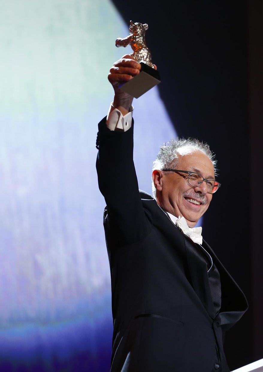 Berlinale director Dieter Kosslick shows the Silver Bear Grand Jury Prize, he accepted on behalf of director Wes Anderson for the movie The Grand Budapest Hotel during the awarding ceremony at the International Film Festival Berlinale in Berlin, Saturday, Jan. 15, 2014. (AP Photo/Axel Schmidt)