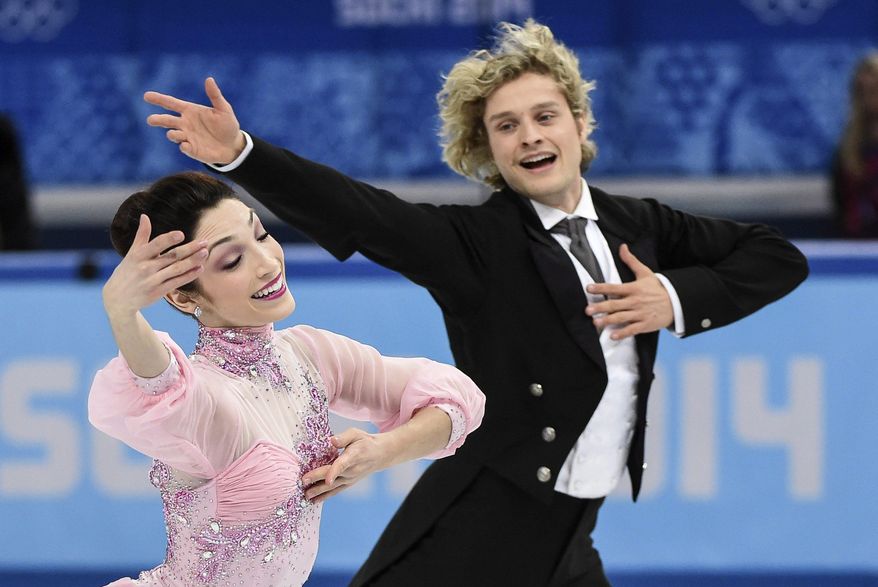 Meryl Davis and Charlie White, of the United States, compete in the ice dance short dance figure skating competition at the Iceberg Skating Palace during the Winter Olympics, Sunday, Feb. 16, 2014, in Sochi, Russia. (AP Photo/The Canadian Press, Paul Chiasson)