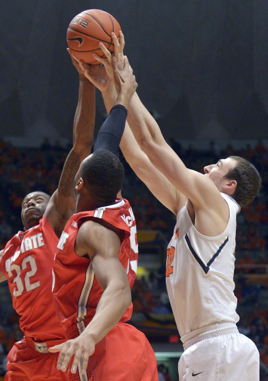 Illinois' Maverick Morgan, right, tries to get an offensive rebound along with Ohio State's guard Lenzelle Smith Jr. (32) and Ohio State's center Trey McDonald during the first half of an NCAA college basketball game in Champaign, Ill., on Saturday, Feb. 15, 2014. (AP Photo/Robin Scholz)