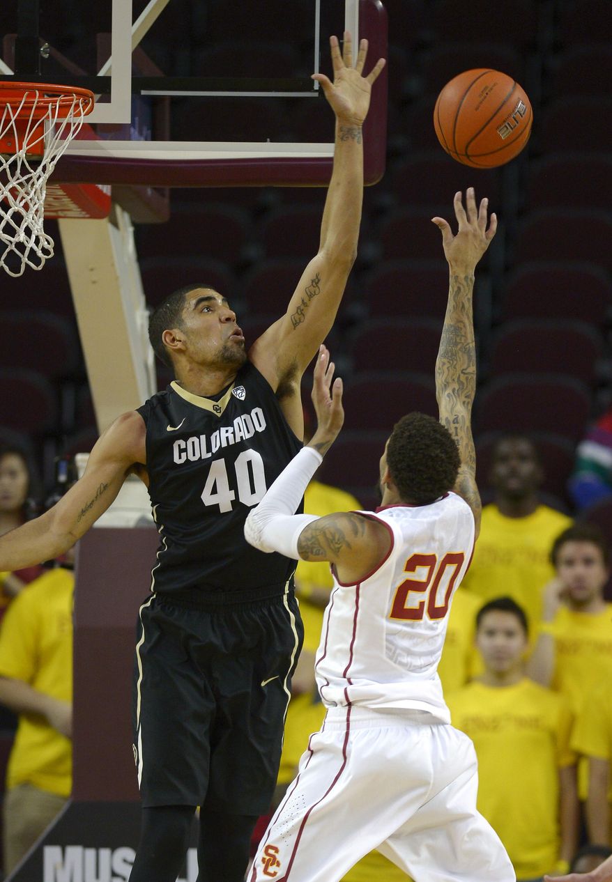 Colorado forward Josh Scott, left, rejects the shot of Southern California guard J.T. Terrell during the first half of an NCAA college basketball game, Sunday, Feb. 16, 2014, Los Angeles. (AP Photo/Mark J. Terrill)