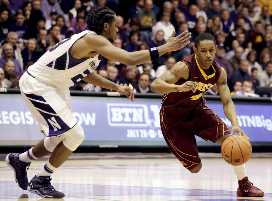 Minnesota guard DeAndre Mathieu, right, drives against Northwestern guard JerShon Cobb during the first half of an NCAA college basketball game in Evanston, Ill., Sunday, Feb. 16, 2014. (AP Photo/Nam Y. Huh)