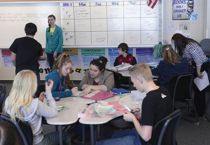 Ninth grade students in Tami Ewell's Language Arts class work on a sentence structure lesson on Jan. 29, 2014 at Copper Mountain Middle School in Herriman, Utah. When lawmakers decided to boost per-pupil spending last year by 2 percent, many Utahns cheered, envisioning that cash raining on teachers and classrooms. In reality, much of that money was spoken for, by the state retirement system, long before it ever hit schools, a Salt Lake Tribune investigation has found. In the Salt Lake City and Alpine school districts, not one cent of the increased student funding made it into classrooms. All of it went to the state retirement system and/or rising health care costs. It's a pattern that could repeat this year unless lawmakers find more money per student than what's so far been proposed. (AP Photo/The Salt Lake Tribune, Al Hartmann)