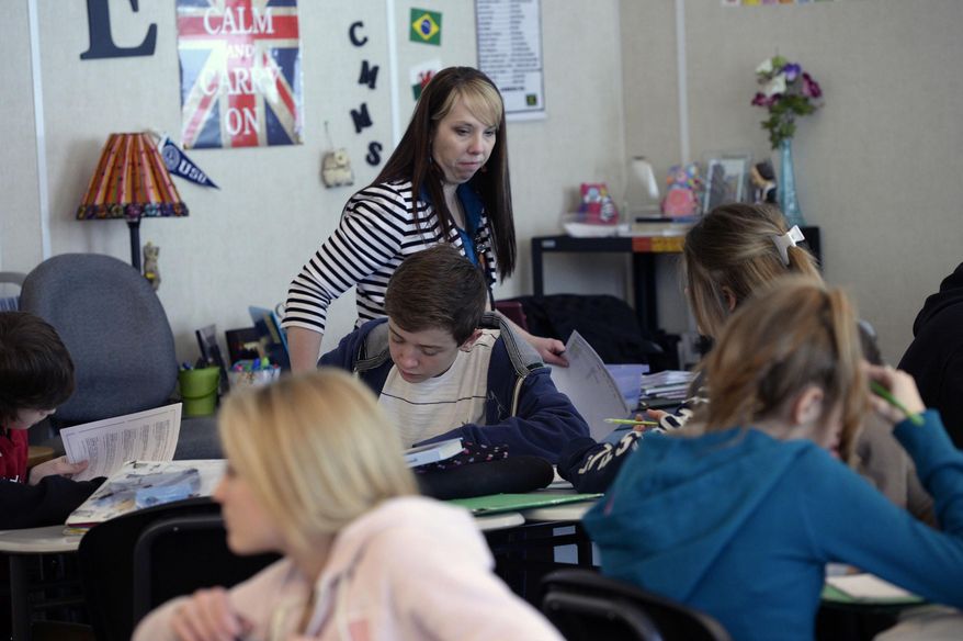 Ninth grade students in Tami Ewell's Language Arts class work on a sentence structure lesson on Jan. 29, 2014 at Copper Mountain Middle School in Herriman, Utah. When lawmakers decided to boost per-pupil spending last year by 2 percent, many Utahns cheered, envisioning that cash raining on teachers and classrooms. In reality, much of that money was spoken for, by the state retirement system, long before it ever hit schools, a Salt Lake Tribune investigation has found. In the Salt Lake City and Alpine school districts, not one cent of the increased student funding made it into classrooms. All of it went to the state retirement system and/or rising health care costs. It's a pattern that could repeat this year unless lawmakers find more money per student than what's so far been proposed. (AP Photo/The Salt Lake Tribune, Al Hartmann)