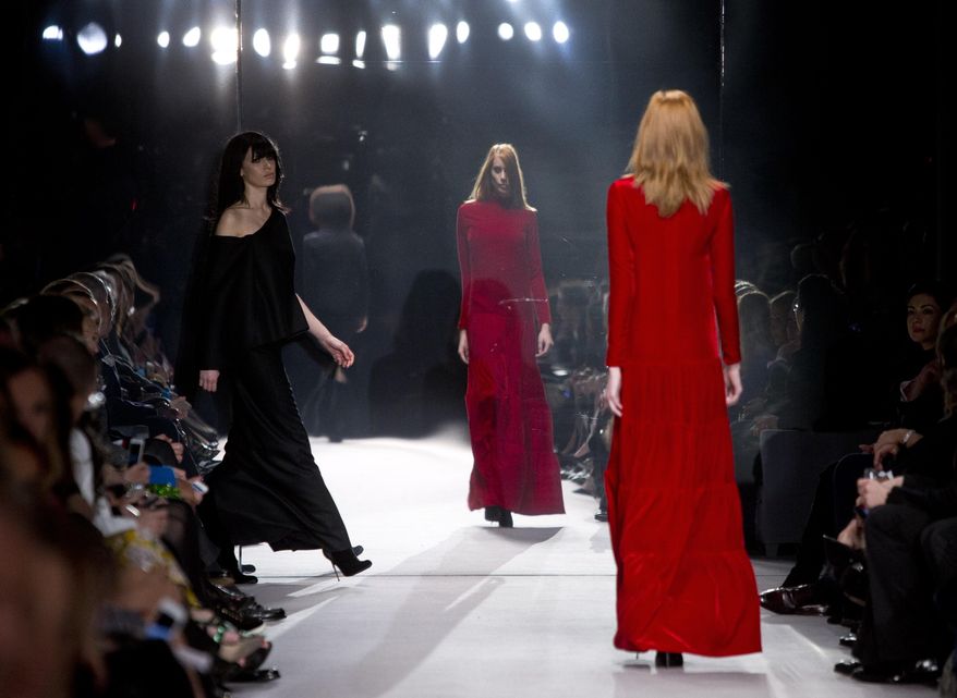 Models wear designs created by Tom Ford during London Fashion Week Autumn/Winter 2014, at Lindley Hall in central London, Monday, Feb. 17, 2014. (Photo by Joel Ryan/Invision/AP)