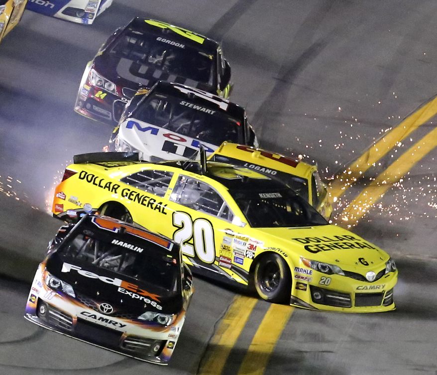 Matt Kenseth (20) slides sideways in front of Joey Logano (22), Tony Stewart (14) and Jeff Gordon (24), starting a multi-car crash in the front stretch during the NASCAR Sprint Unlimited auto race at Daytona International Speedway in Daytona Beach, Fla., Saturday, Feb. 15, 2014. Denny Hamlin, front, escaped the wreck. (AP Photo/David Graham)
