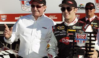 Austin Dillon, right, holds up the pole award with car owner and grandfather Richard Childress after qualifying for the pole position in the Daytona 500 NASCAR Sprint Cup Series auto race at Daytona International Speedway in Daytona Beach, Fla., Sunday, Feb. 16, 2014. (AP Photo/Terry Renna)