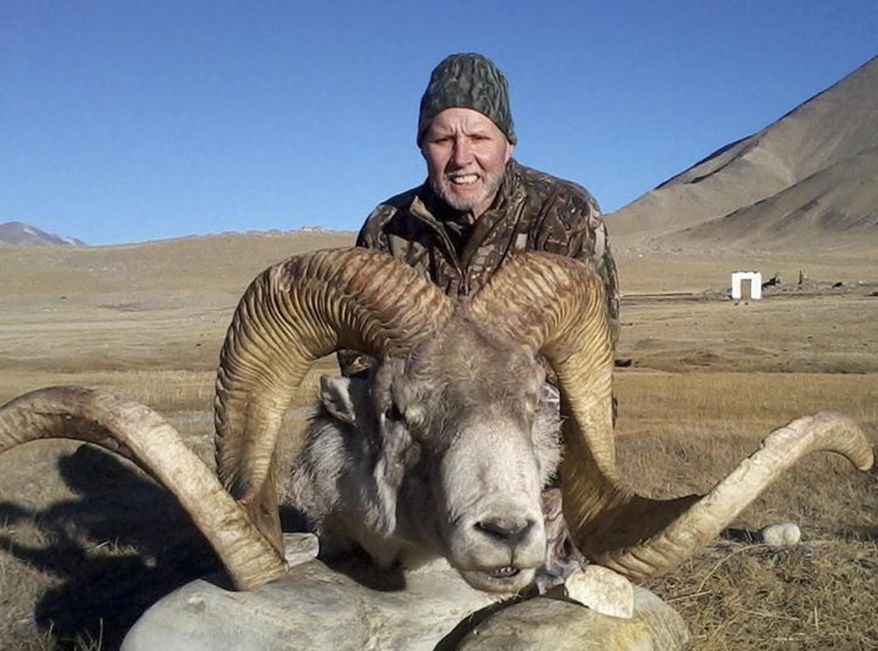 This Dec. 2012 photo provided by Rick Vukasin shows Vukasin, 65, of Great Falls, Mont., posing with a rare argali sheep known as the "Marco Polo'' that he shot in the Pamir mountains of northeast Tajikistan near Karakul Lake along the Chinese border. Vukasin filed a lawsuit in U.S. District Court in Reno on Feb. 6, 2014 against a Tajikistani guide and Canadian outfitter he accuses of defrauding him by shipping him horns taken from an animal other than the 58-inch long ones he says belonged to the sheep he shot. (AP Photo/Rick Vukasin)