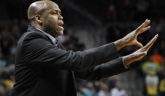 Oregon State head coach Craig Robinson signals to his team during the second half of an NCAA college basketball game against Oregon in Eugene, Ore., Sunday, Feb. 16, 2014. (AP Photo/Chris Pietsch)