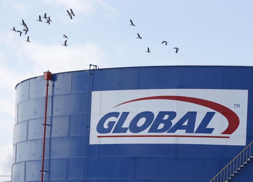 Canada geese fly over a Global Partners storage tank at the Port of Albany on Friday, Feb. 7, 2014, in Albany, N.Y. The Port of Albany has become a hub for the U.S. oil business, taking shipments from North Dakota's Bakken Shale daily by mile-long trains and shipping it in tankers down the Hudson River to refineries. Opponents of a proposal to build boilers to liquefy heavy crude passing through Albany by rail are drawing attention to the capital’s emergence as a major hub for the transport of oil that’s widely considered risky from an environmental and safety standpoint. (AP Photo/Mike Groll)