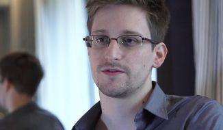 In this June 9, 2013, photo provided by The Guardian Newspaper in London, former NSA contractor Edward Snowden is shown. (AP Photo/The Guardian, Glenn Greenwald and Laura Poitras, File)