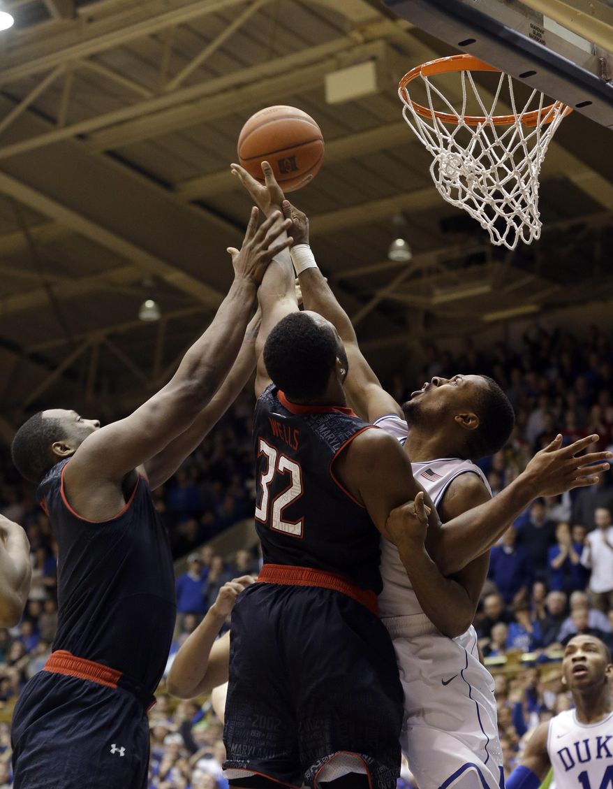 Duke's Tyler Thornton, right, defends the basket from Maryland's Charles Mitchell, left, and Dez Wells (32) as Maryland attempts to score in the closing moments of an NCAA college basketball game in Durham, N.C., Saturday, Feb. 15, 2014. Duke won 69-67. (AP Photo/Gerry Broome)