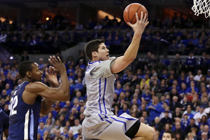Creighton's Doug McDermott, right, goes for a layup past Villanova's James Bell (32) in the first half of an NCAA college basketball game in Omaha, Neb., Sunday, Feb. 16, 2014. Doug McDermott matched his season high with 39 points and passed Larry Bird for 13th place on the Division I career scoring chart as Creighton won 101-80. (AP Photo/Nati Harnik)