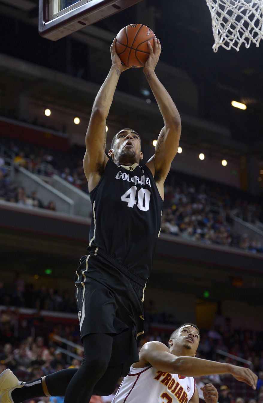 Colorado forward Josh Scott, left, puts up a shot as Southern California guard Chass Bryan defends during the first half of an NCAA college basketball game, Sunday, Feb. 16, 2014, Los Angeles. (AP Photo/Mark J. Terrill)