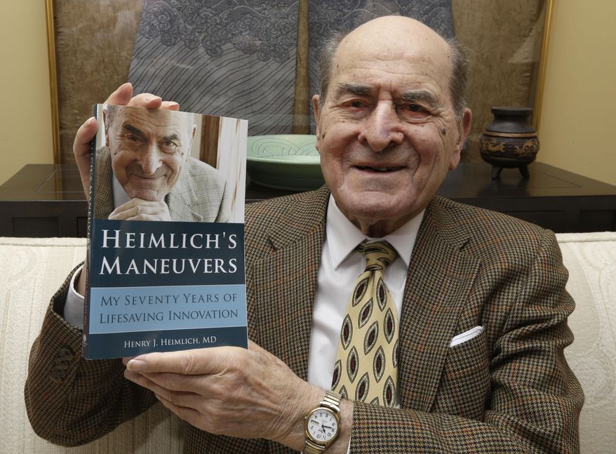 In this Wednesday, Feb. 5, 2014 photo, Dr. Henry Heimlich holds his memoirs prior to being interviewed at his home in Cincinnati. Heimlich is known for developing the Heimlich maneuver that has been used to clear obstructions from the windpipes of choking victims around the world for four decades. (AP Photo/Al Behrman)