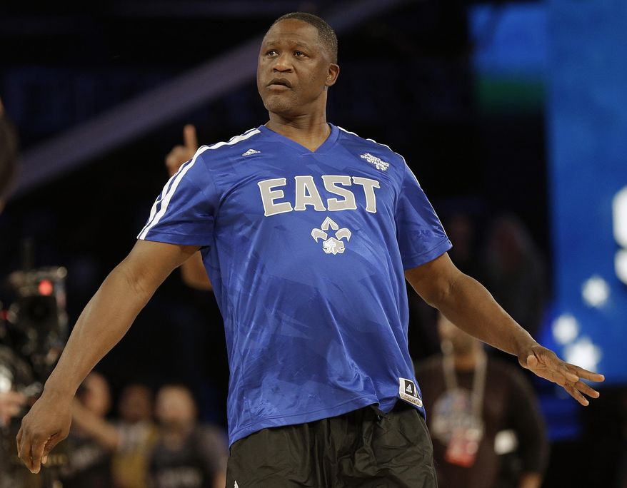 Former NBA player Dominique Wilkins watches his shot during the skills competition at the NBA All Star basketball game, Saturday, Feb. 15, 2014, in New Orleans. (AP Photo/Gerald Herbert)