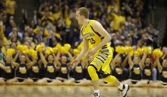 CORRECTS MARQUETTE PLAYER TO JAKE THOMAS, INSTEAD OF STEVE TAYLOR JR. - Marquette&#39;s Jake Thomas reacts after he made a 3-point basket against Xavier during the second half of an NCAA college basketball game Saturday, Feb. 15, 2014, in Milwaukee. (AP Photo/Jeffrey Phelps)