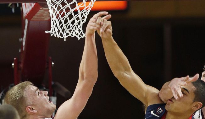 Arizona&#x27;s Nick Johnson (13) has his shot blocked by Arizona State&#x27;s Jonathan Gilling (31) and is hit in the face by Arizona State&#x27;s Jordan Bachynski during the first half of an NCAA college basketball game on Friday, Feb. 14, 2014, in Tempe, Ariz. (AP Photo/Ross D. Franklin)