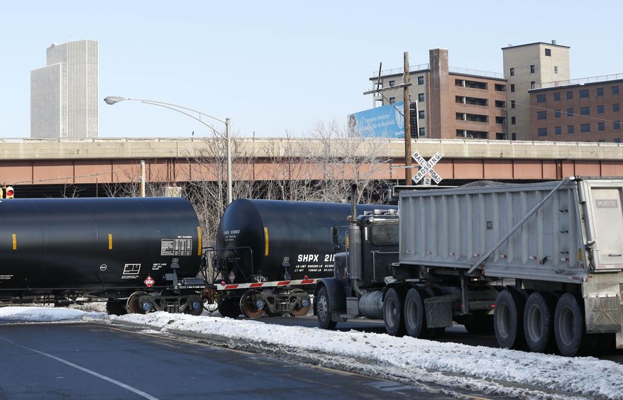 A truck waits as railroad oil tanker cars arrive at the Port of Albany on Friday, Feb. 7, 2014, in Albany, N.Y. The Port of Albany has become a hub for the U.S. oil business, taking shipments from North Dakota's Bakken Shale daily by mile-long trains and shipping it in tankers down the Hudson River to refineries. Opponents of a proposal to build boilers to liquefy heavy crude passing through Albany by rail are drawing attention to the capital’s emergence as a major hub for the transport of oil that’s widely considered risky from an environmental and safety standpoint. (AP Photo/Mike Groll)