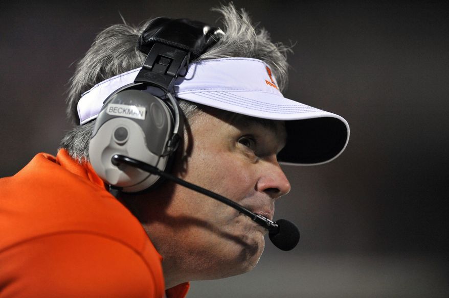 FILE - In this Oct. 19, 2013, file photo, Illinois head coach Tim Beckman watches during the last minutes of the fourth quarter of an NCAA college football game against Wisconsin in Champaign, Ill. Among the questions facing administrators in the wake of Michael Sam’s announcement that he is gay, is not only how to teach tolerance and acceptance of gay athletes within the athletic department, but how to enforce it. Beckman said if a player did use a gay slur against another teammate he’d first ask the team’s “honor council”, a group of 14 players selected by teammates. to address the situation.(AP Photo/Paul Beaty)