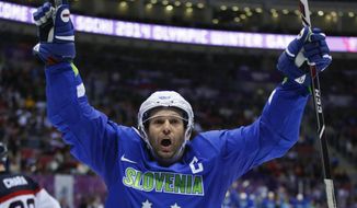 Slovenia forward Tomaz Razingar reacts after scoring a goal against Slovakia in the third period of a men&#x27;s ice hockey game at the 2014 Winter Olympics, Saturday, Feb. 15, 2014, in Sochi, Russia. (AP Photo/Julio Cortez)