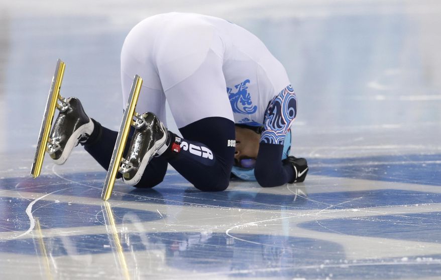 Victor An of Russia celebrates winning in a men's 1000m short track speedskating final at the Iceberg Skating Palace during the 2014 Winter Olympics, Saturday, Feb. 15, 2014, in Sochi, Russia. (AP Photo/Darron Cummings)