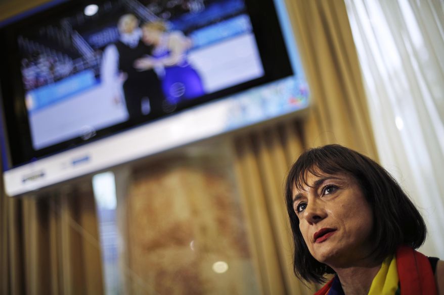 Vladimir Luxuria, a former Communist lawmaker in the Italian parliament and prominent crusader for transgender rights, sits for an interview, Monday, Feb. 17, 2014, in central Sochi, Russia, home of the 2014 Winter Olympics. Luxuria said she was detained by police at the Olympics after being stopped while carrying a rainbow flag that read in Russian: "Gay is OK." Police on Monday denied this happened. (AP Photo/David Goldman)