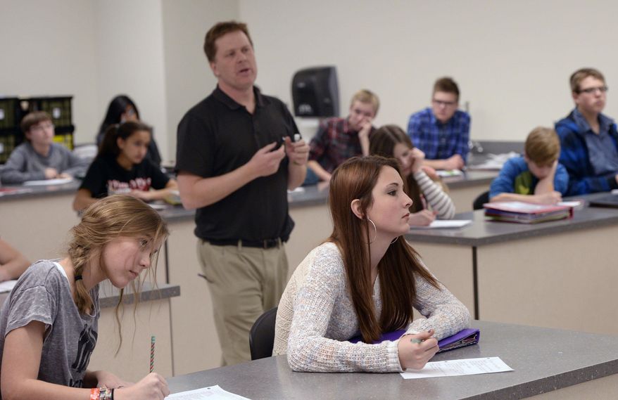 Ninth grade students in John Schneggenburger's biology class learn how to map pedigrees in genetics at Copper Mountain Middle School on Jan. 29, 2014 in Herriman, Utah. When lawmakers decided to boost per-pupil spending last year by 2 percent, many Utahns cheered, envisioning that cash raining on teachers and classrooms. In reality, much of that money was spoken for, by the state retirement system, long before it ever hit schools, a Salt Lake Tribune investigation has found. In the Salt Lake City and Alpine school districts, not one cent of the increased student funding made it into classrooms. All of it went to the state retirement system and/or rising health care costs. It's a pattern that could repeat this year unless lawmakers find more money per student than what's so far been proposed. (AP Photo/The Salt Lake Tribune, Al Hartmann)