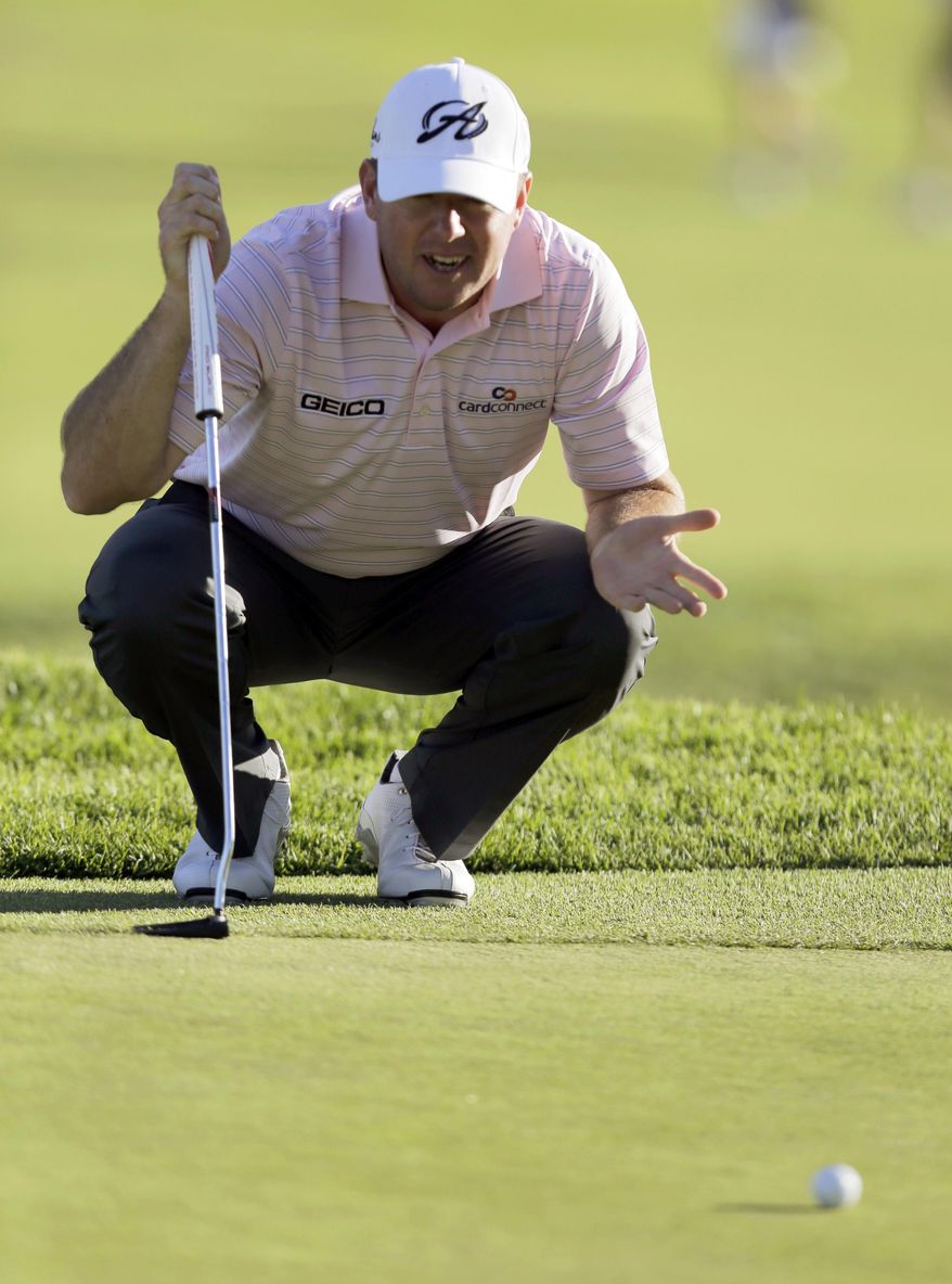 Robert Garrigus eyes what became his birdie putt on the ninth green in the second round of the Northern Trust Open golf tournament at Riviera Country Club in the Pacific Palisades area of Los Angeles, Friday, Feb. 14, 2014. (AP Photo/Reed Saxon)