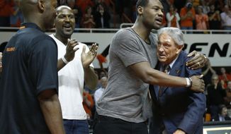Former Oklahoma State basketball player Tony Allen, second from right, hugs former head coach Eddie Sutton, right, during ceremonies in honor of the 2004 OSU team which reached the Final Four, during halftime of an NCAA college basketball game between Oklahoma and Oklahoma State in Stillwater, Okla., Saturday, Feb. 15, 2014. Looking on at left are John Lucas III and Ivan McFarlin. (AP Photo/Sue Ogrocki)