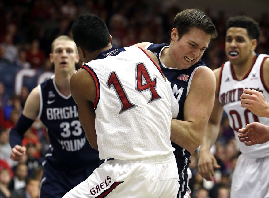 BYU's Luke Worthington, front right, and Saint Mary's Stephen Holt (14) fight for the ball in the first half of an NCAA college basketball game on Saturday, Feb. 15, 2014, in Moraga, Calif. (AP Photo/Ben Margot)