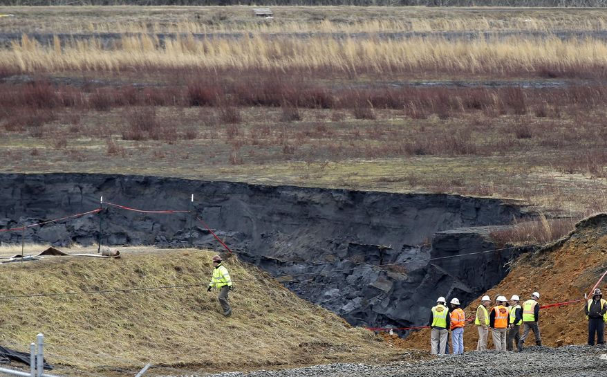 FILE - In a Wednesday, Feb. 5, 2014 file photo, Duke Energy engineers and contractors survey the site of a coal ash spill at the Dan River Power Plant in Eden, N.C. as state and federal environmental officials continued their investigations of the spill into the river. A legislative oversight committee has called for officials from the N.C. Department of Environment and Natural Resources to appear at a hearing on Monday, Feb. 17, 2014 to talk about the spill. North Carolina lawmakers State Senate Rules Chairman Tom Apodaca and House Environment Committee Vice-Chairman Chuck McGrady say they will co-sponsor a bill seeking the removal of coal ash dumps like the one that ruptured Feb. 2. (AP Photo/Gerry Broome, File)