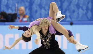 Meryl Davis and Charlie White of the United States compete in the ice dance free dance figure skating finals at the Iceberg Skating Palace during the 2014 Winter Olympics, Monday, Feb. 17, 2014, in Sochi, Russia. (AP Photo/Darron Cummings)