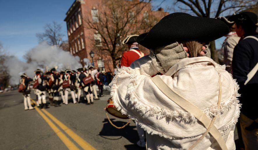 Will, Sedgwick of Hanover, Md., covers his ears as soldiers with the 1st Virginia Reenactors fire their muskets during the annual Old Town Alexandria President's Day Parade, Alexandria, Va., Monday, February 17, 2014. (Andrew Harnik/The Washington Times)