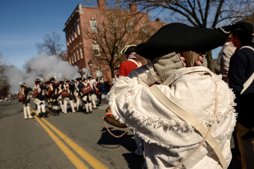 Will, Sedgwick of Hanover, Md., covers his ears as soldiers with the 1st Virginia Reenactors fire their muskets during the annual Old Town Alexandria President's Day Parade, Alexandria, Va., Monday, February 17, 2014. (Andrew Harnik/The Washington Times)