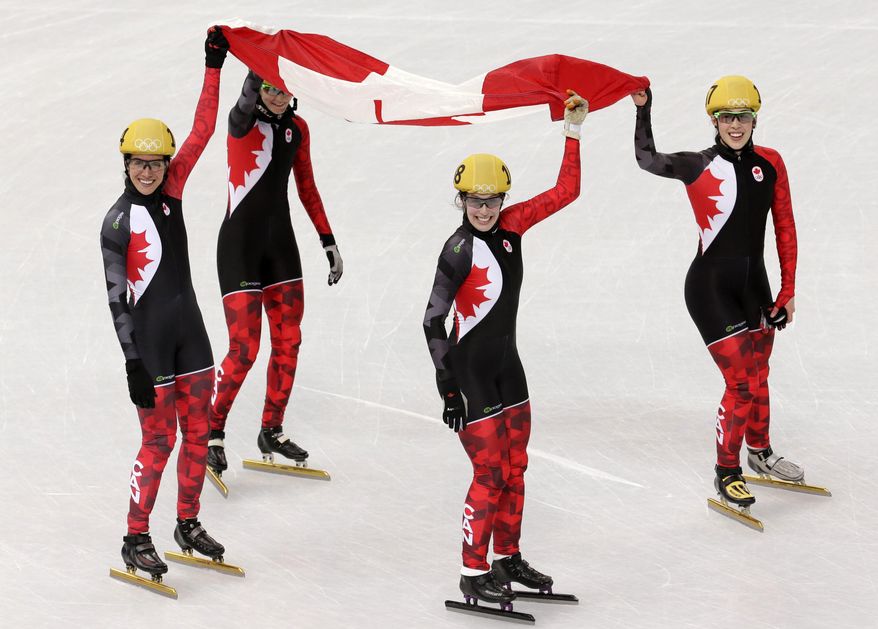 The Canadian team celebrate their second place in the women's 3000m short track speedskating relay final at the Iceberg Skating Palace during the 2014 Winter Olympics, Tuesday, Feb. 18, 2014, in Sochi, Russia. (AP Photo/Bernat Armangue)
