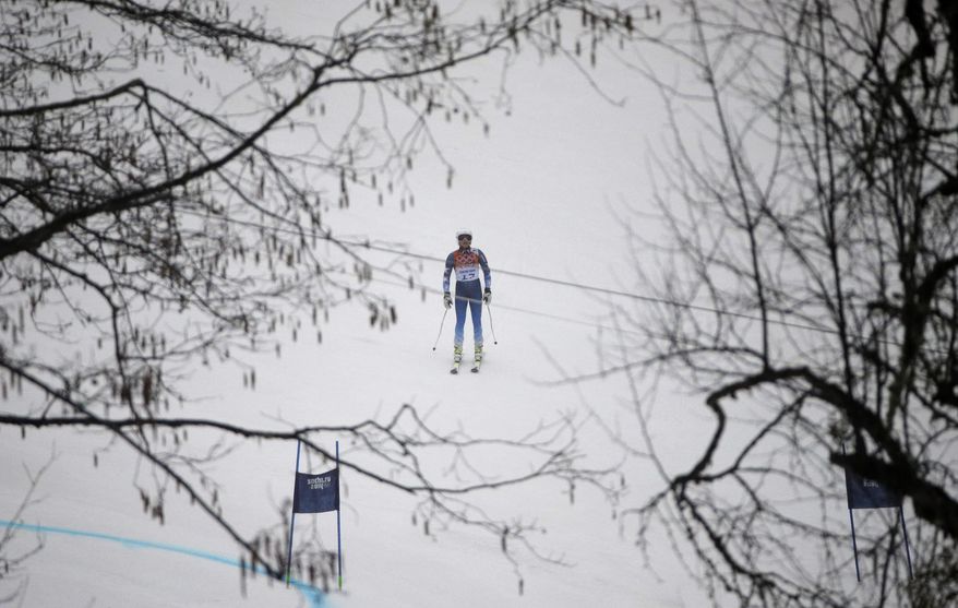 United States' Julia Mancuso pauses on the course after skiing out of the first run of the women's giant slalom at the Sochi 2014 Winter Olympics, Tuesday, Feb. 18, 2014, in Krasnaya Polyana, Russia. (AP Photo/Gero Breloer)