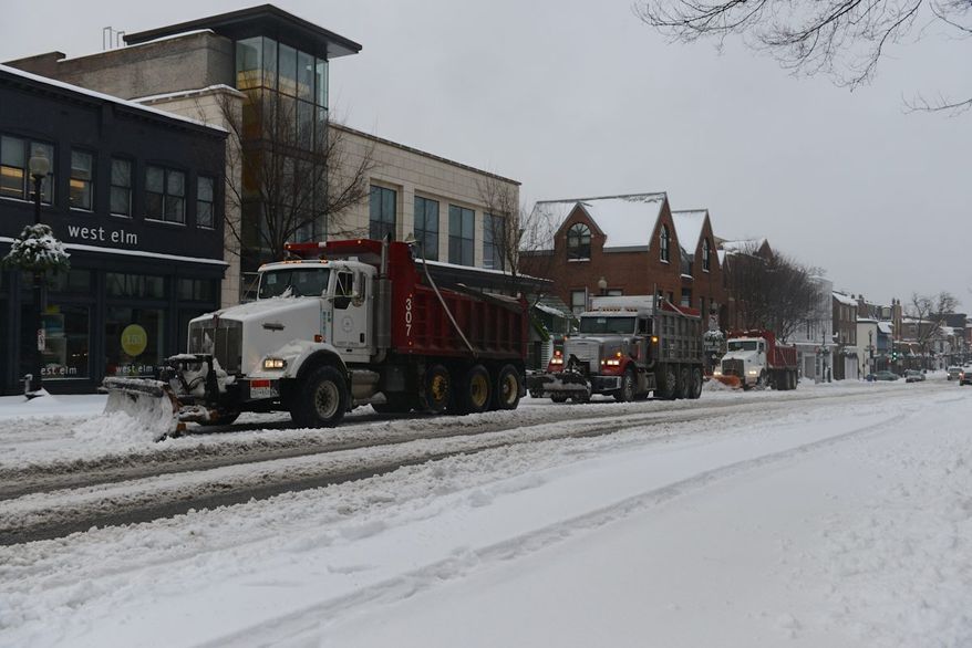 Snow plows clear M St. in Northwest Washington, D.C., on Thursday, February 13, 2014. (Lloyd Villas/The Washington Times).