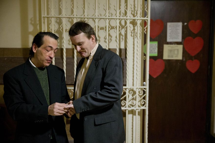 Bob, left, and Bill Sullivan take off their wedding rings before entering the marriage license bureau at City Hall, Tuesday, Feb. 18, 2014, in Philadelphia. The Sullivans were denied a marriage license along with an effort have their out-of-state marriage recognized. The Sullivans say they married four years ago in Vermont, but don't enjoy the legal benefits of marriage in Pennsylvania. (AP Photo/Matt Rourke)