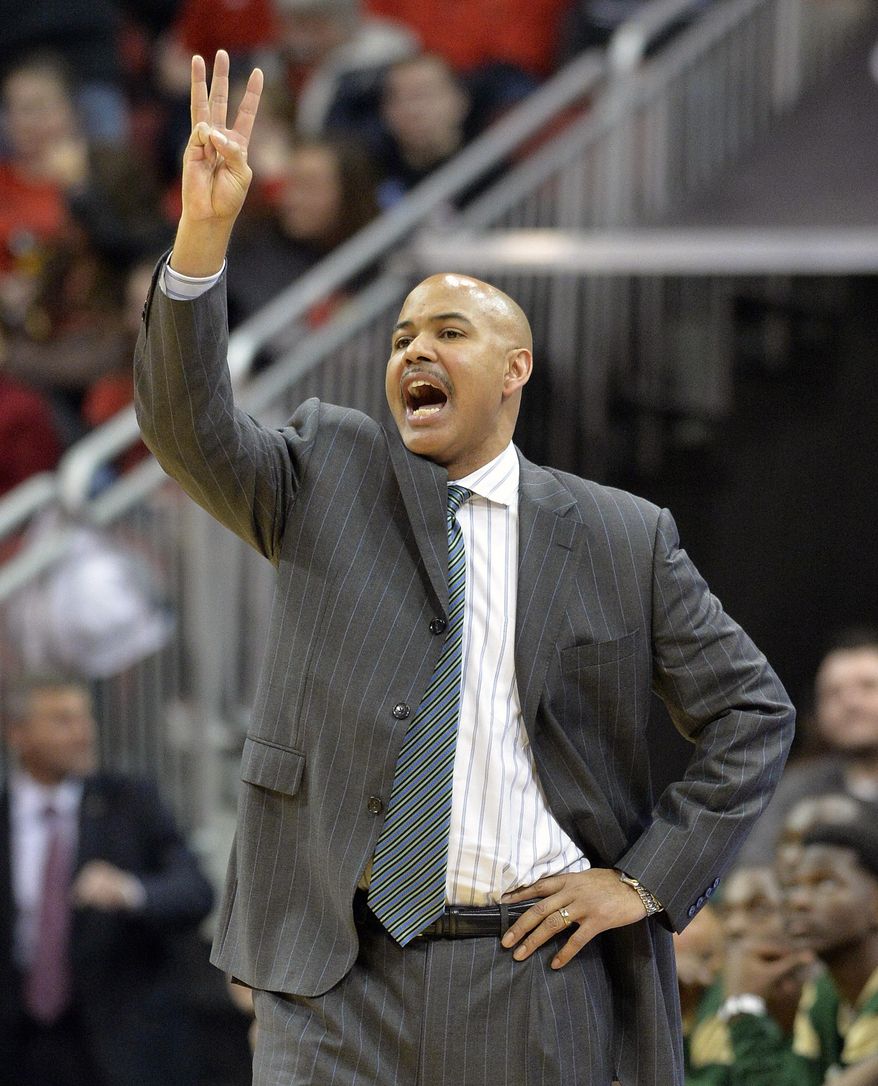South Florida head coach Stan Heath sends a play into his team during the first half of an NCAA college basketball game against Louisville, Tuesday, Feb. 18, 2014, in Louisville, Ky. (AP Photo/Timothy D. Easley)