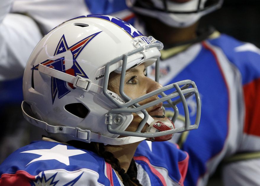 Texas Revolution's Jennifer Welter watches the team's Indoor Football League game against the North Texas Crunch on (Saturday, Feb. 15, 2014, in Allen, Texas. Welter became what is believed to be the first woman who wasn't a kicker or holder to play in a men's pro football game. The 5-foot-2, 130-pound resident of North Texas was thrown for a 1-yard loss on her first carry as a running back (AP Photo/The Dallas Morning News, Vernon Bryant) MANDATORY CREDIT; MAGS OUT; TV OUT; INTERNET USE BY AP MEMBERS ONLY; NO SALES