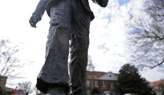 A flower is seen on the James Meredith statue at the University of Mississippi in Oxford, Miss., Tuesday, Feb. 18, 2014.  Campus police at the University of Mississippi are checking video surveillance footage in the area around a statue of James Meredith that was found sullied Sunday morning.  (AP Photo/The Daily Mississippian, Thomas Graning)