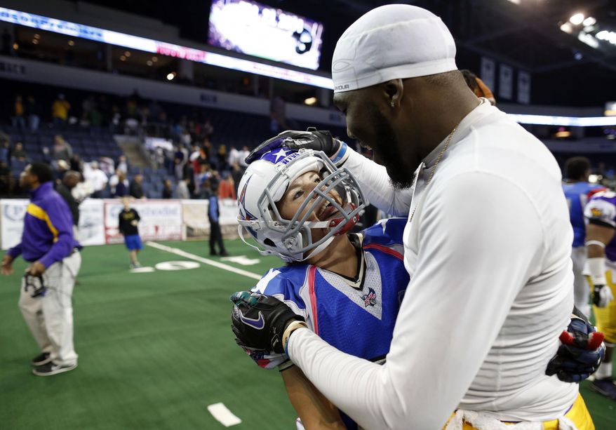 Texas Revolution's Jennifer Welter (47) is complimented by North Texas Crunch defender Cedric Hearvey after a preseason Indoor Football League game (Saturday, Feb. 15, 2014, in Allen, Texas. Hearvey tackled Welter, a running back, on her third carry of the game, in the fourth quarter. (AP Photo/The Dallas Morning News, Vernon Bryant) MANDATORY CREDIT; MAGS OUT; TV OUT; INTERNET USE BY AP MEMBERS ONLY; NO SALES