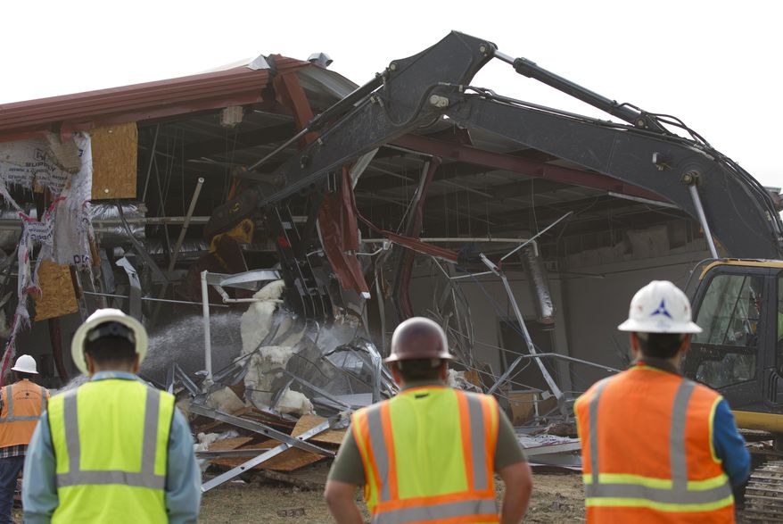 This undated photo provided by the Fort Hood Public Affairs Office shows Building 42003 being demolished in Fort Hood, Texas. Fort Hood officials said Tuesday, Feb. 18, 2014, that they have torn down Building 42003, the site of a 2009 massacre that left 13 people dead and more than 30 wounded. They plan to place trees, a gazebo and a memorial plaque at the site.(AP Photo/Fort Hood Public Affairs Office)