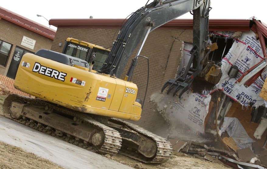 This undated photo provided by the Fort Hood Public Affairs Office shows Building 42003 being demolished in Fort Hood, Texas. Fort Hood officials said Tuesday, Feb. 18, 2014, that they have torn down Building 42003, the site of a 2009 massacre that left 13 people dead and more than 30 wounded. They plan to place trees, a gazebo and a memorial plaque at the site.(AP Photo/Fort Hood Public Affairs Office)