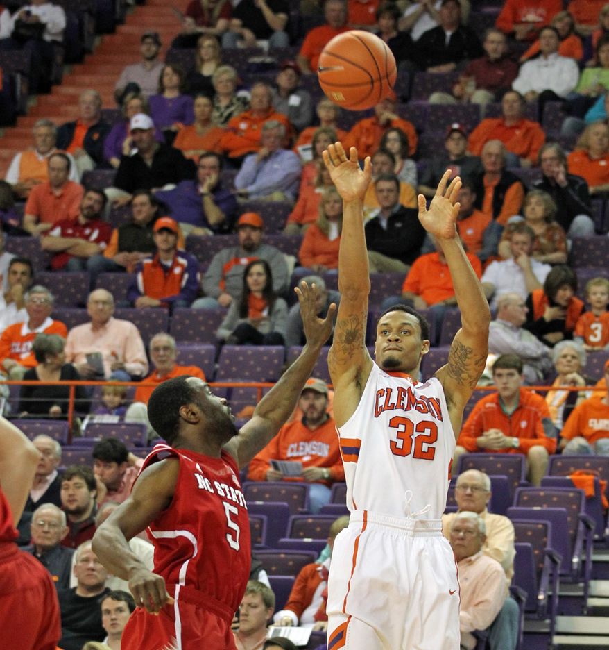 Clemson's K.J. McDaniels, right, shoots over North Carolina State's Desmond Lee during the first half of an NCAA college basketball game Tuesday, Feb. 18, 2014, in Clemson, S.C. Clemson won 73-56. (AP Photo/Anderson Independent-Mail, Ken Ruinard) GREENVILLE NEWS OUT SENECA JOURNAL OUT