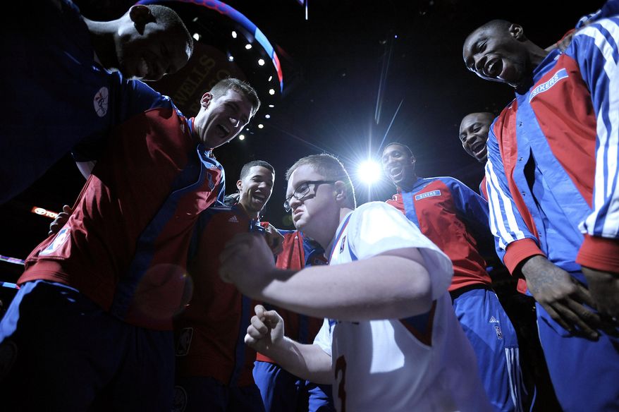 Kevin Grow participates in the Philadelphia 76ers pre-game huddle before an NBA basketball game against the Cleveland Cavaliers on Tuesday, Feb. 18, 2014, in Philadelphia. Kevin has been signed by the Philadelphia 76ers to a ceremonial two-day contract. (AP Photo/Michael Perez)