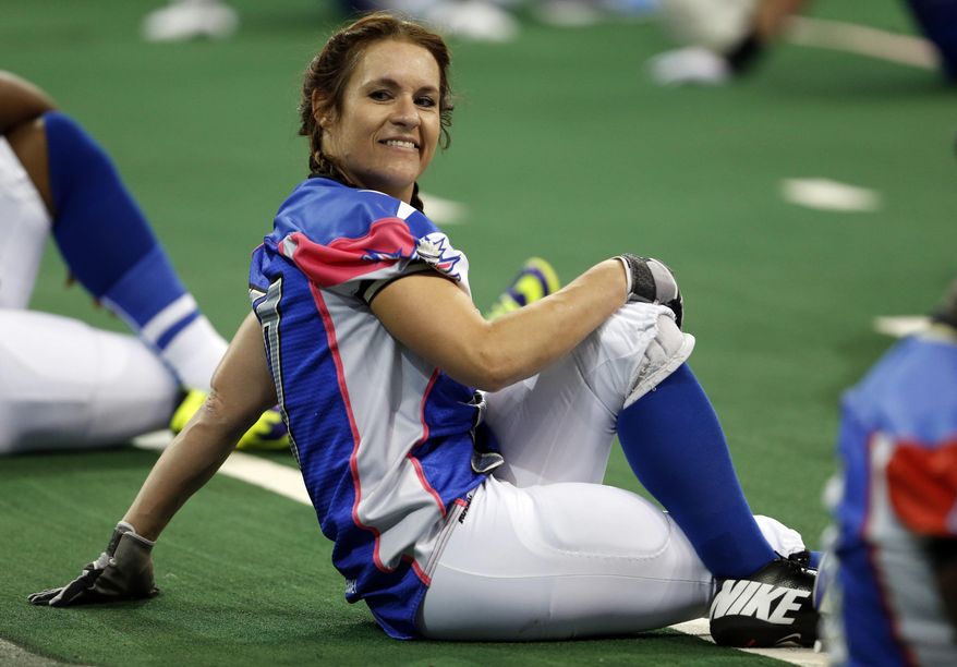 Texas Revolution's Jennifer Welter warms up for the Revolution's Indoor Football League game against the North Texas Crunch on Saturday, Feb. 15, 2014, in Allen, Texas. Welter became what is believed to be the first woman who wasn't a kicker or holder to play in a men's pro football game. The 5-foot-2, 130-pound resident of North Texas was thrown for a 1-yard loss on her first carry as a running back. (AP Photo/The Dallas Morning News, Vernon Bryant) MANDATORY CREDIT; MAGS OUT; TV OUT; INTERNET USE BY AP MEMBERS ONLY; NO SALES